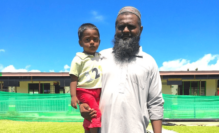 Head teacher Shahim Mussein and his son Muhibullah stand in front of Dobuilevu Muslim School (Photo: Lachlan Forsyth) 
