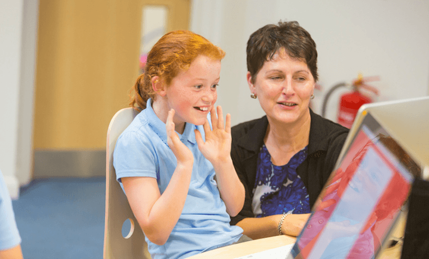 Young girl with a computer in the classroom 

