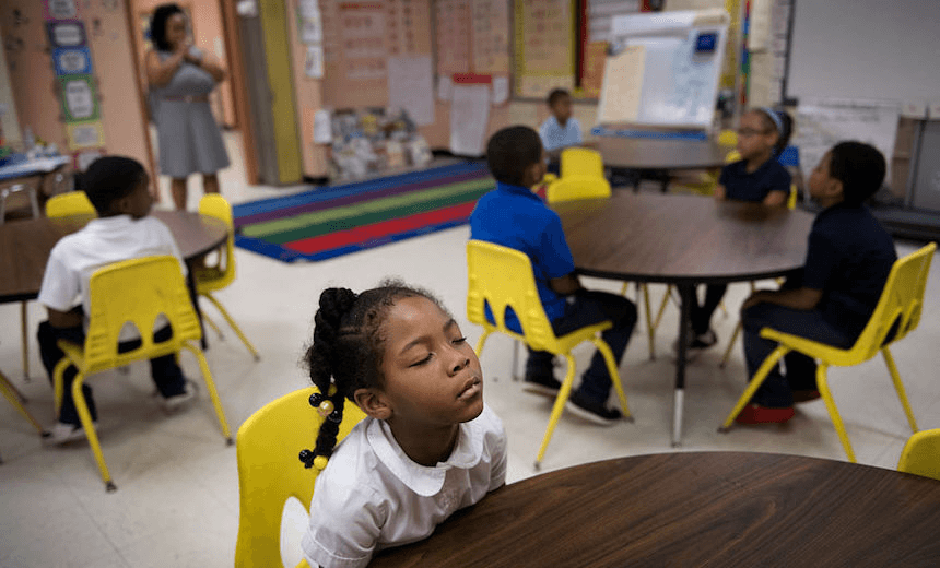 Haiven Spence, age 6, during morning meditation with other first graders at the Robert W Coleman Elementary School in Baltimore, MD on November 2, 2016. The school replaced detention and instead is using mindfulness and meditation as an alternative to discipline. They say it helps children find calmness and control in the chaos of their lives.  Last year school officials said they had no suspensions.The meditation room at the school was created by a partnership with the Holistic Life Foundation.   (Photo by Linda Davidson / The Washington Post via Getty Images) 
