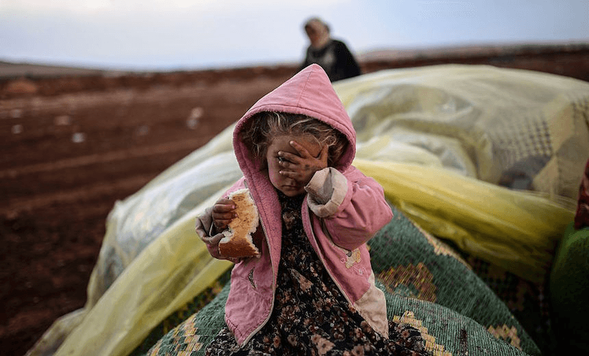 A Syrian Kurdish woman wait with her daughter near the Syria/Turkey border on October 2, 2014. (BULENT KILIC/AFP/Getty Images) 

