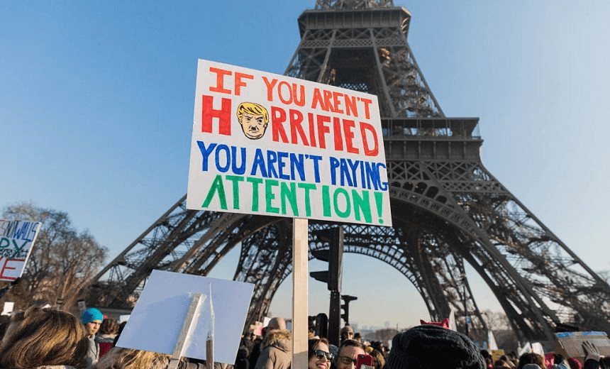 PARIS, FRANCE – JANUARY 21: Demonstrators carrying banners and placards take part in the Women’s March next to the Eiffel Tower on the Parvis des Droits de l’Homme on January 21, 2017 in Paris, France. The Women’s March originated in Washington DC but soon spread to be a global march calling on all concerned citizens to stand up for equality, diversity and inclusion and for Women’s Rights to be recognized around the world as Human Rights. Global marches are now being held, on the same day, across seven continents. (Photo by Christophe Morin/IP3/Getty Images) 
