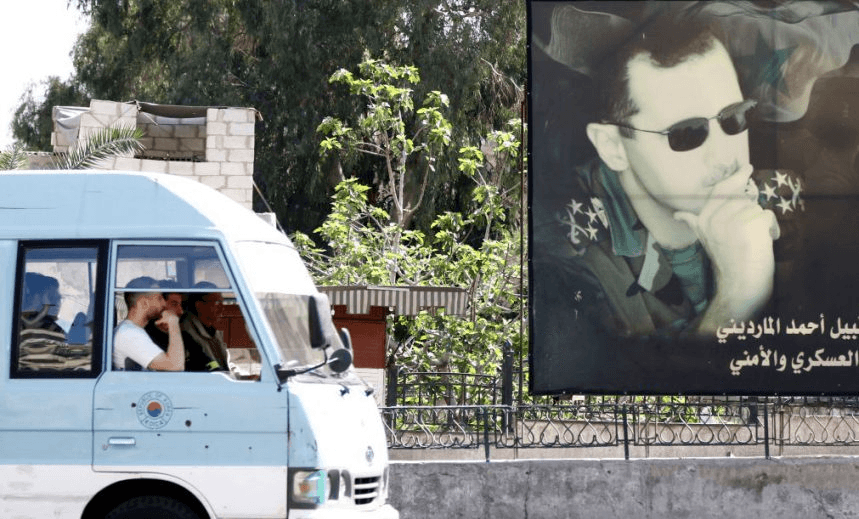 A minivan drives past a portrait of Syrian President Bashar al-Assad in Damascus on April 7, 2017. 
US forces fired a barrage of cruise missiles at a Syrian airbase in response to what President Donald Trump called a “barbaric” chemical attack he blamed on the Damascus regime. / AFP PHOTO / Louai Beshara        (Photo credit should read LOUAI BESHARA/AFP/Getty Images) 
