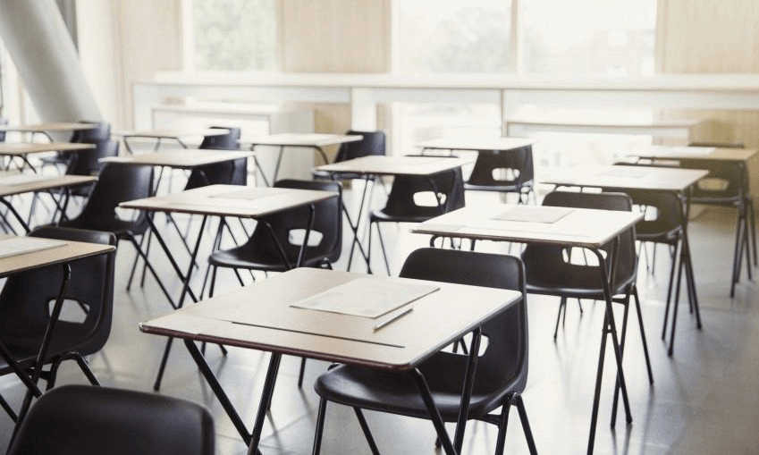 Tests on desks in empty classroom
