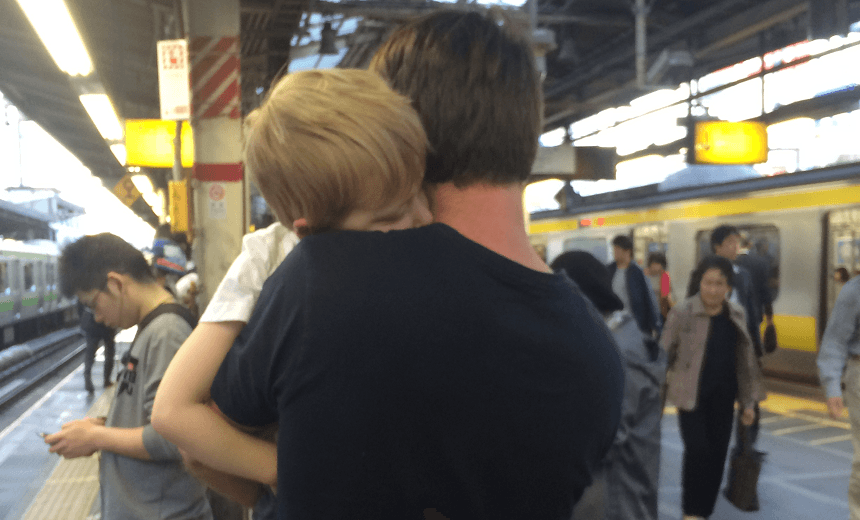 Gareth and his son have a hug. 
