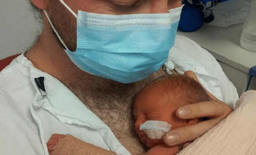 Daniel holds his daughter 
