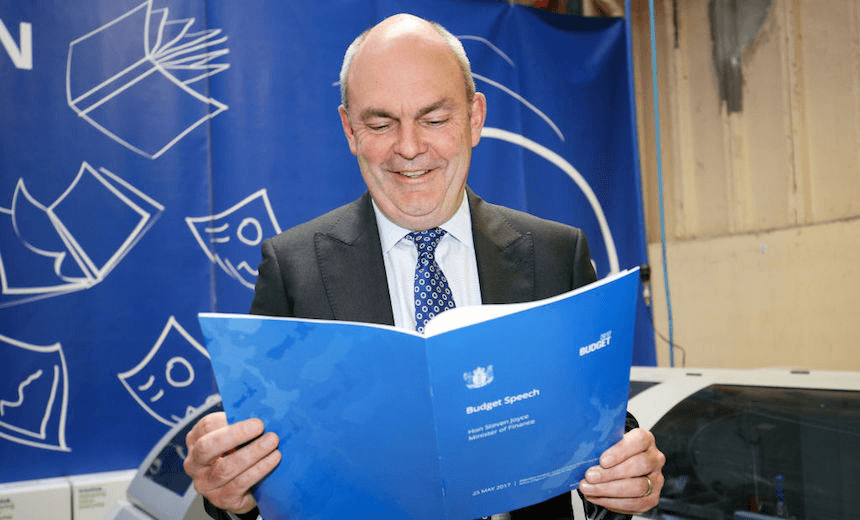 Finance Minister Steven Joyce looks over a copy of his budget speech during the printing of the budget at Printlink on May 23, 2017 in Wellington. (Photo by Hagen Hopkins/Getty Images) 
