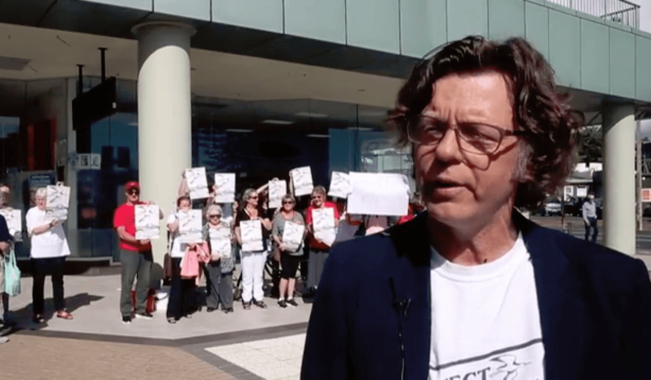 Devonport Peninsual Precincts Society spokesperson Iain Rea and supporters protesting outside a hearing in Takapuna on the proposed development 
