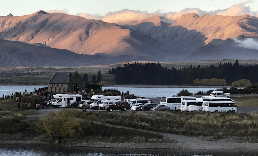 Tekapo’s Church of the Good Shepherd surrounded by campervans. Photo: Peter Newport 
