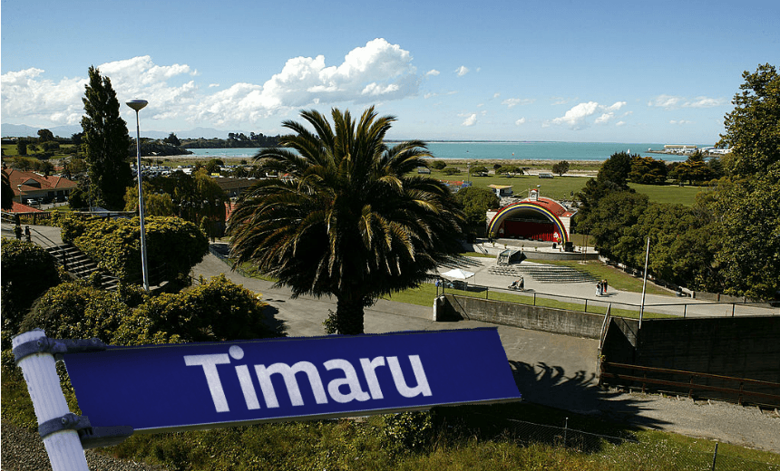 a sunny backgroun, a nikau and a sign saying 'timaru'