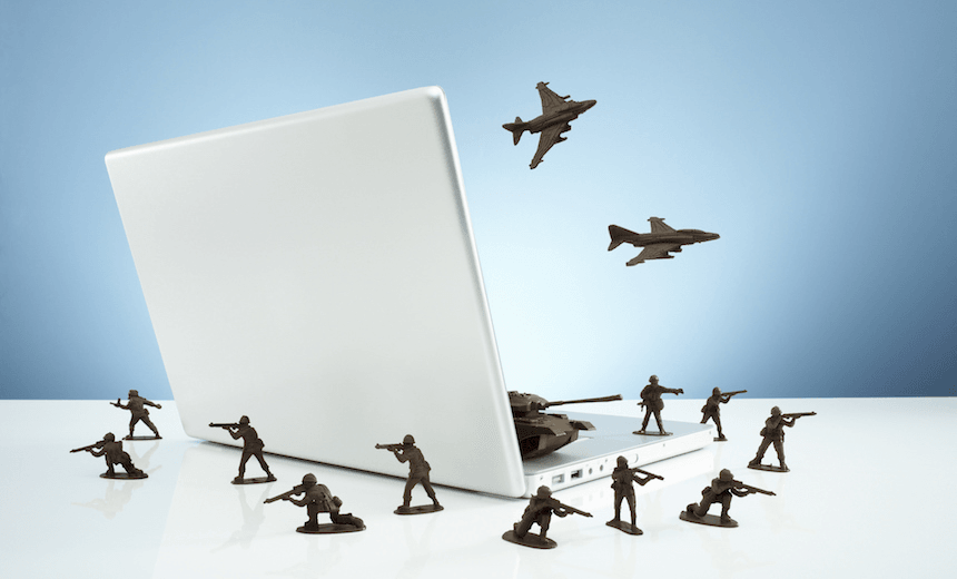 Toy soldiers in a &#8216;firewall&#8217; around laptop