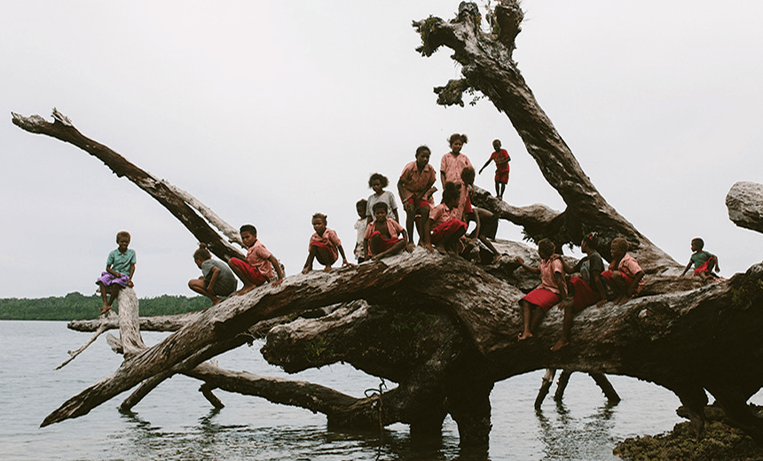 Children of West ‘Are’are play on a recently fallen 300 year old tree (Photo: Jo Currie)