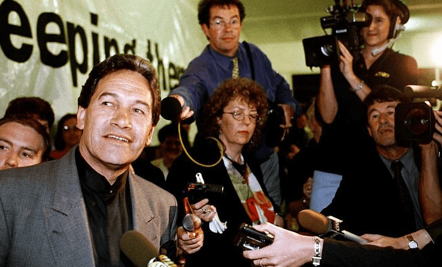 New Zealand First leader Winston Peters watches the election results under the watchful eye of the media at Tauranga Racecourse, November 1999. (Photo by David Hallett/Getty Images)