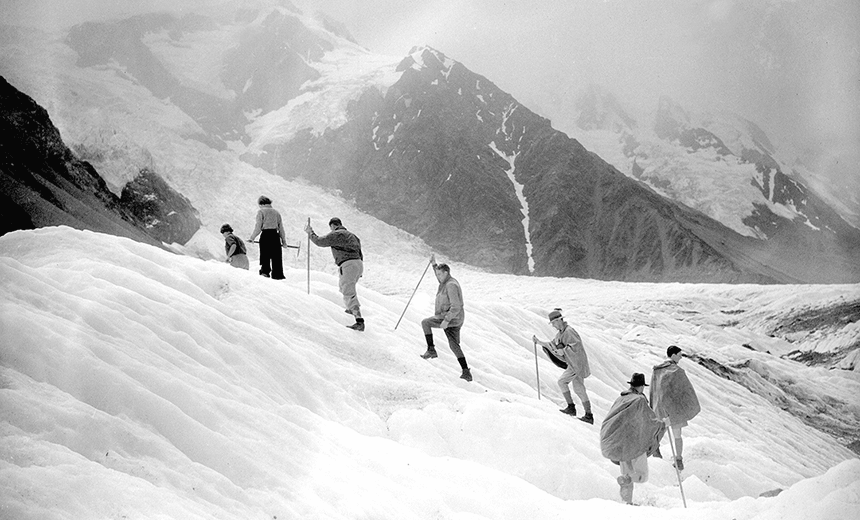 21st February 1935:  Two New Zealand girls leading a climbing party across the ice at the famous Tasman Glacier, Mount Cook, New Zealand.  (Photo by PNA Rota/Getty Images) 
