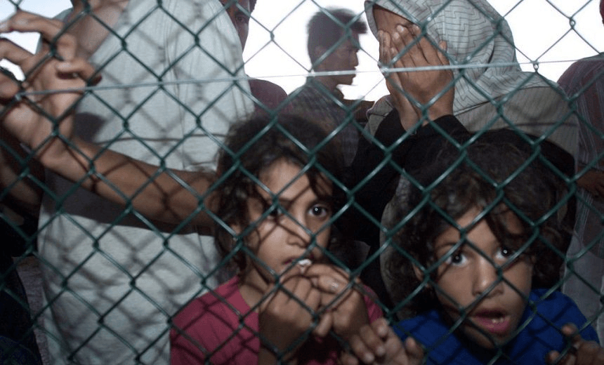Asylum seekers from Norwegian freighter the MV Tampa and local fishing boat the Aceng arrive at Nauru off the Australian coast on 19 September 2001. (Photo by Fairfax Media/Fairfax Media via Getty Images) 
