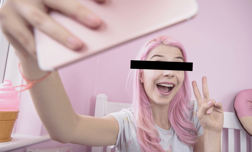 Woman with dyed pink hair posting a selfie to social media. Photo: Getty Images 
