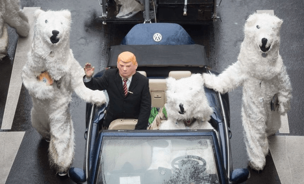 A demonstrator dressed as US President Donald Trump waves from a car as he parades with other activists dressed as polar bears during a protest of the action group “No Climate Change” on November 11, 2017 in Bonn, western Germany, where is taking place the COP23 United Nations Climate Change Conference. / AFP PHOTO / dpa / Bernd Thissen / Germany OUT        (Photo credit should read BERND THISSEN/AFP/Getty Images) 
