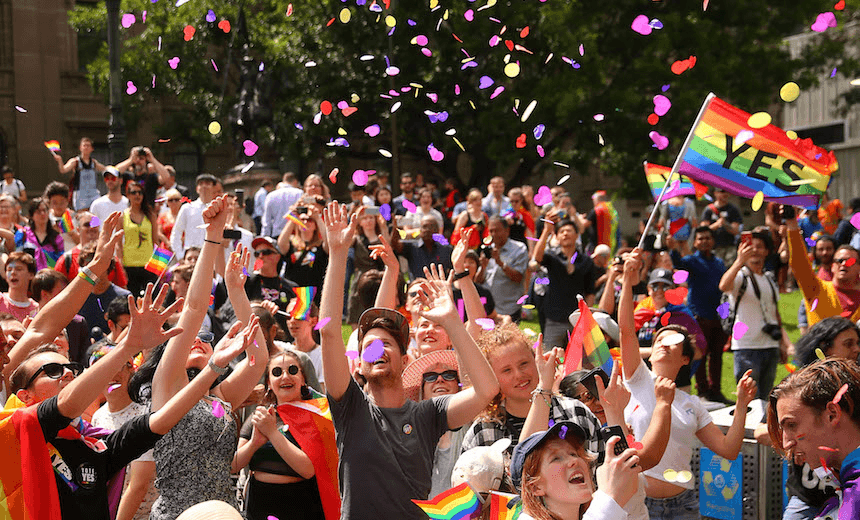 MELBOURNE, AUSTRALIA – NOVEMBER 15:  People in the crowd celebrate as the result is announced during the Official Melbourne Postal Survey Result Announcement at the State Library of Victoria on November 15, 2017 in Melbourne, Australia. Australians have voted for marriage laws to be changed to allow same-sex marriage, with the Yes vote defeating No. Despite the Yes victory, the outcome of Australian Marriage Law Postal Survey is not binding, and the process to change current laws will move to the Australian Parliament in Canberra.  (Photo by Scott Barbour/Getty Images) 

