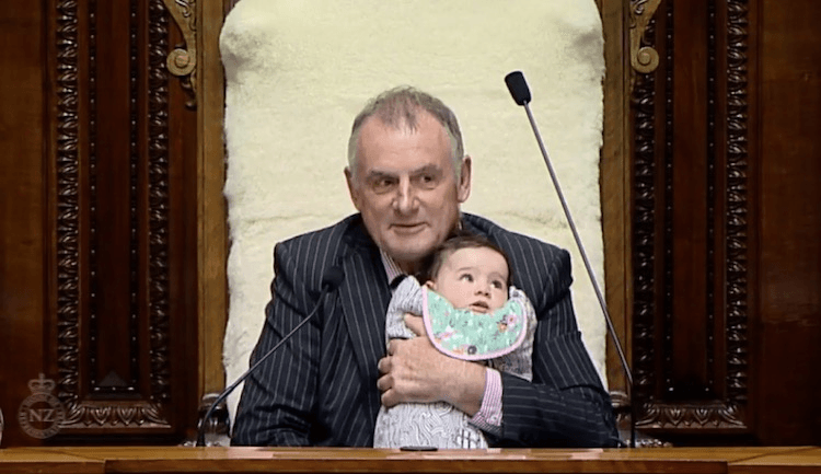 Speaker of the House Trevor Mallard holds Labour MP Willow Jean Prime’s daughter during a debate on extending paid parental leave. Screengrab: TVNZ 
