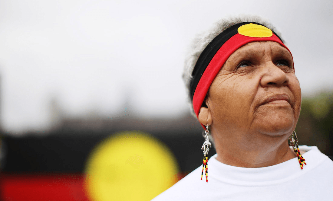 Indigenous Australian Joan Baker, daughter of Ruby Williams who was taken from her family at three years of age, poses in celebration after watching the live televsion broadcast from Australian Parliament in Canberra as Australian Prime Minister Kevin Rudd delivered an apology to the Aboriginal people for injustices committed over two centuries of white settlement on February 13, 2008 in Sydney, Australia. Rudd’s apology referred to the “past mistreatment” of all Aborigines, singling out the “Stolen Generations”, the tens of thousands of Aboriginal children taken from their families by governments between 1910 and the early 1970s, in a bid to assimilate them into white society. (Photo by Kristian Dowling/Getty Images)