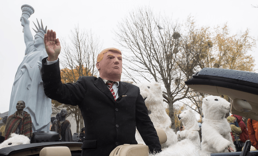A demonstrator dressed as US President Donald Trump waves from a car as he parades with other activists dressed as polar bears during a protest of the action group “No Climate Change” on November 11, 2017 in Bonn, western Germany, where is taking place the COP23 United Nations Climate Change Conference. / AFP PHOTO / dpa / Bernd Thissen / Germany OUT        (Photo credit should read BERND THISSEN/AFP/Getty Images) 
