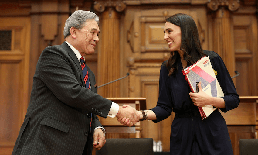 Prime Minister Jacinda Ardern and NZ First leader Winston Peters shake hands during a coalition agreement signing, 2018 (Photo: Hagen Hopkins/Getty Images) 
