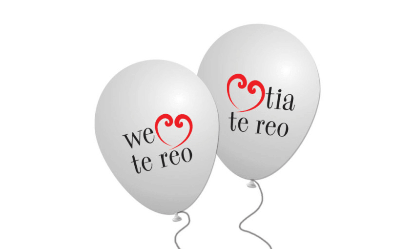 Two white ballons that say We heart te reo and arohatia te reo