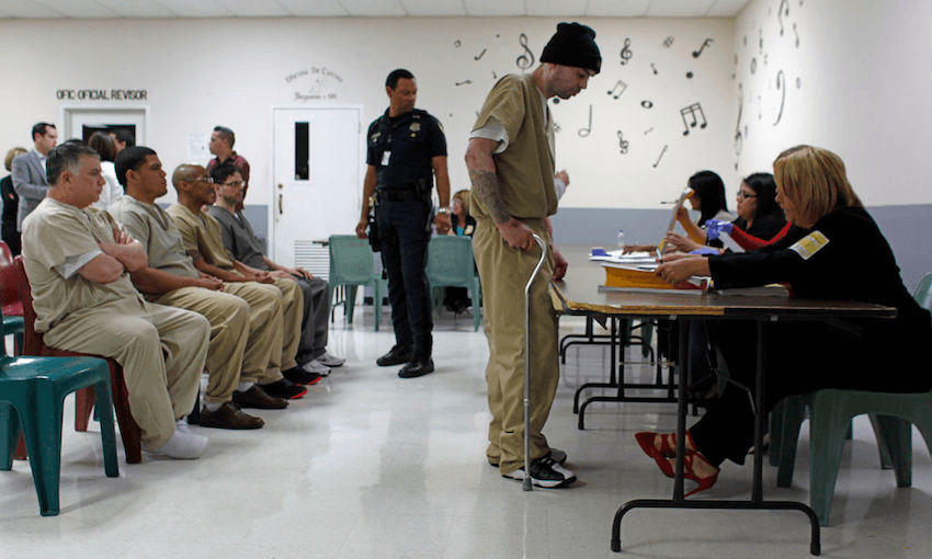 Electoral workers (R) give instructions to inmate voters in Puerto Rico at a prison in Bayamon (RICARDO ARDUENGO/AFP/Getty Images) 

