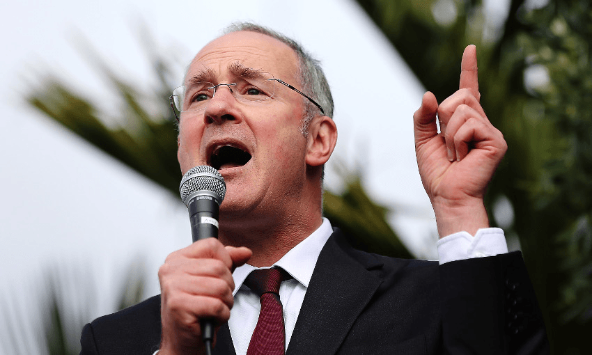 Phil Twyford pointing in the direction of income thresholds for Kiwibuild houses. Photo: Hannah Peters/Getty Images. 
