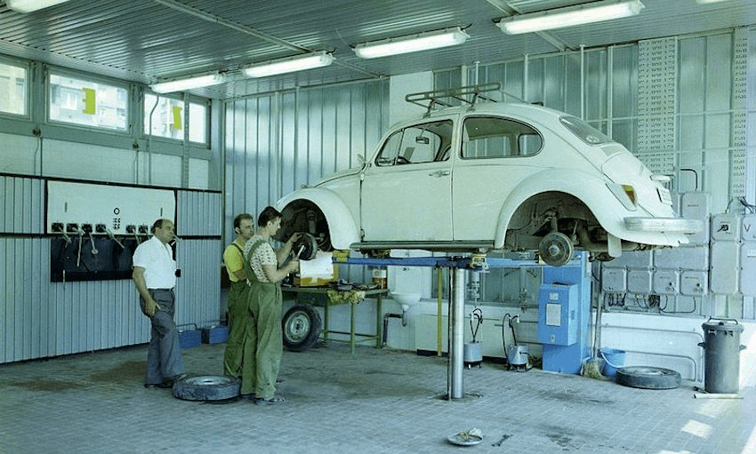 A Volkswagen Beetle being worked on in a garage, Hungary, Budapest, 1978. 
