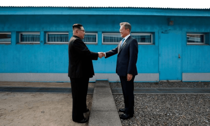 Kim Jong-un shakes hands with Moon Jae-in at the Military Demarcation Line. Photo: KOREA SUMMIT PRESS POOL/AFP/Getty Images 
