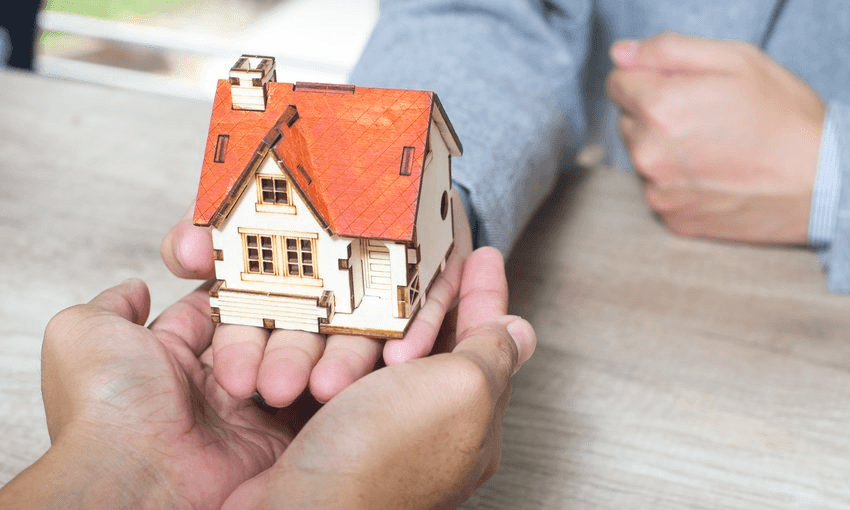 A house in the palms of giant people from an unknown planet. Photo: Getty 
