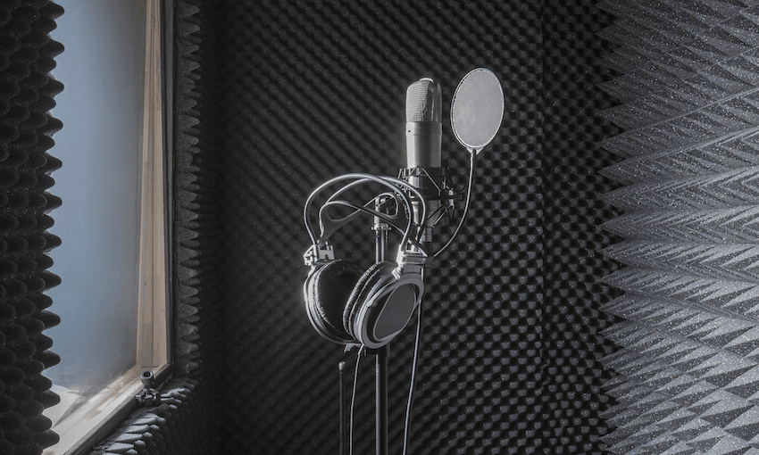 Close-up of headphones on microphone stand in soundproof recording studio