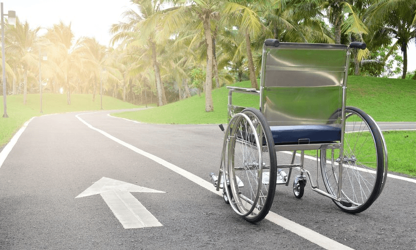 Empty Wheelchair On Road With Arrow Symbol