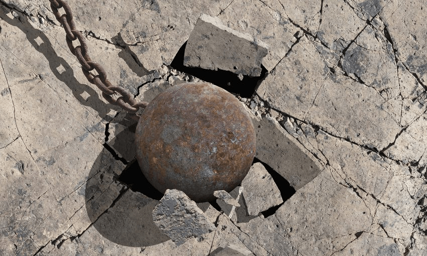 Close up of wrecking ball cracking concrete 
