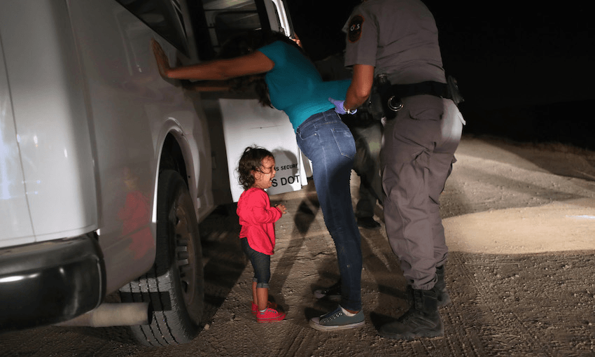 A two-year-old Honduran asylum seeker cries as her mother is searched near the U.S.-Mexico border on June 12, 2018 in McAllen, Texas. The asylum seekers had rafted across the Rio Grande from Mexico and were detained by U.S. Border Patrol agents.  (Photo by John Moore/Getty Images) 
