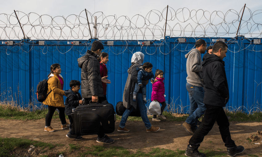 A Syrian family walks towards the gate to cross between Serbia and Hungary. (Photo by Omar Marques/SOPA Images/LightRocket via Getty Images) 
