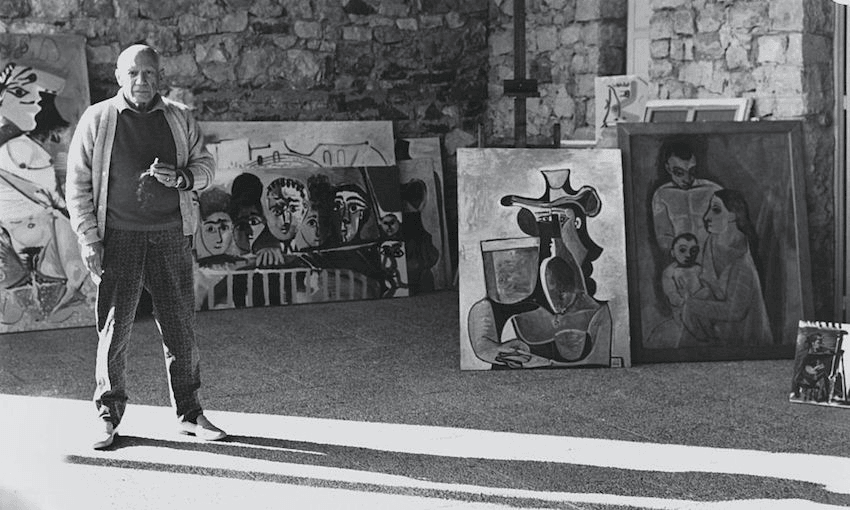 Pablo Picasso standing in front of his paintings at home, Notre Dame de Vie (south of France) (Photo by Cecil Beaton/Condé Nast via Getty Images) 
