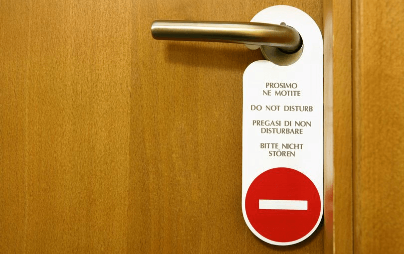 “Do Not Disturb sign on a hotel room door (the text message is in four languages). Space for text, high resolution – 16 Mpx.” 
