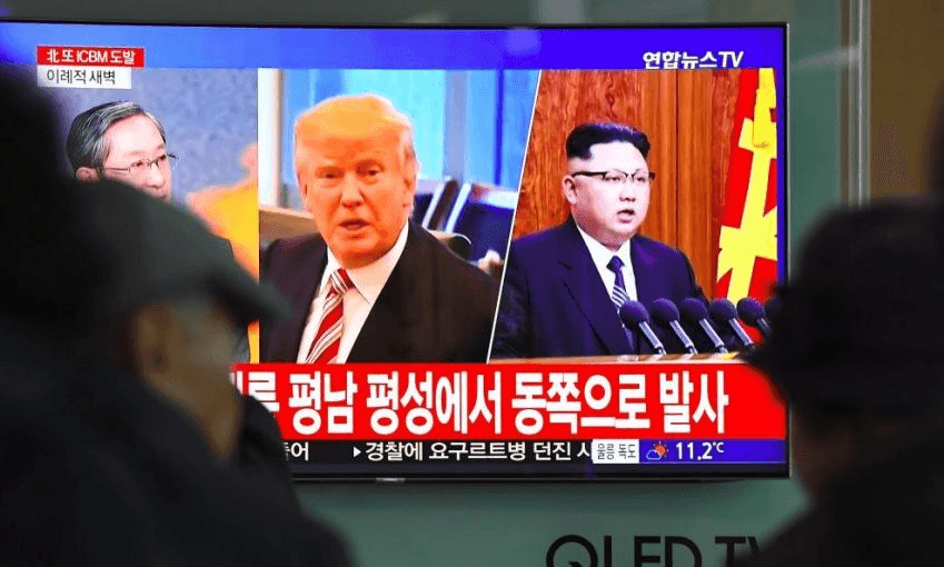 A television in Seoul shows pictures of Donald Trump Kim Jong-Un. Photo: JUNG YEON-JE/AFP/Getty Images 
