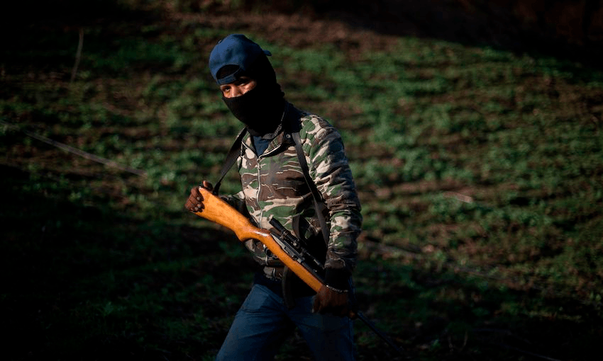 A Guerrero Community Police member patrols at an illegal poppy field, in Heliodoro Castillo, Guerrero state, Mexico (Image: PARDO/AFP/Getty Images)