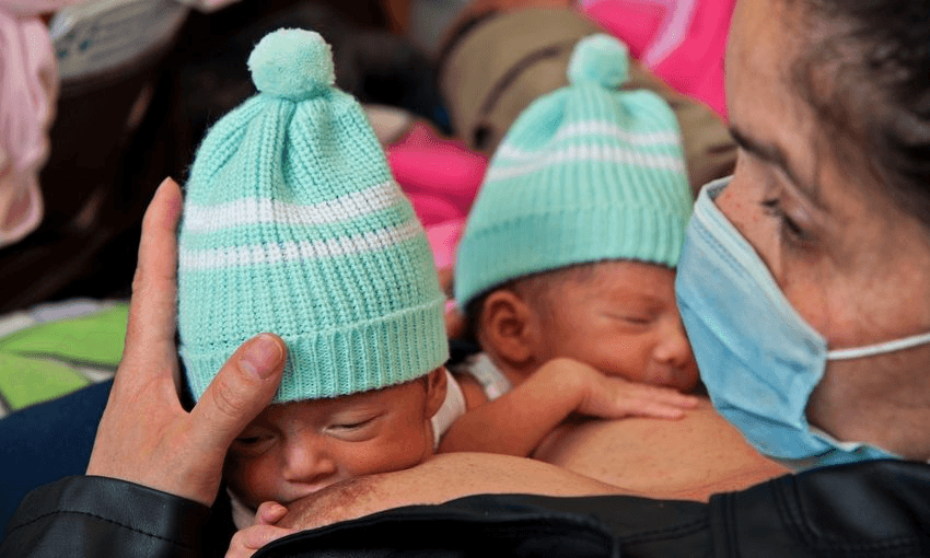 A mother breastfeeds her premature babies at the San Ignacio hospital in Bogota, Colombia, using the skin-to-skin ‘kangaroo care’ technique. Photo: GUILLERMO LEGARIA/AFP/Getty Images 
