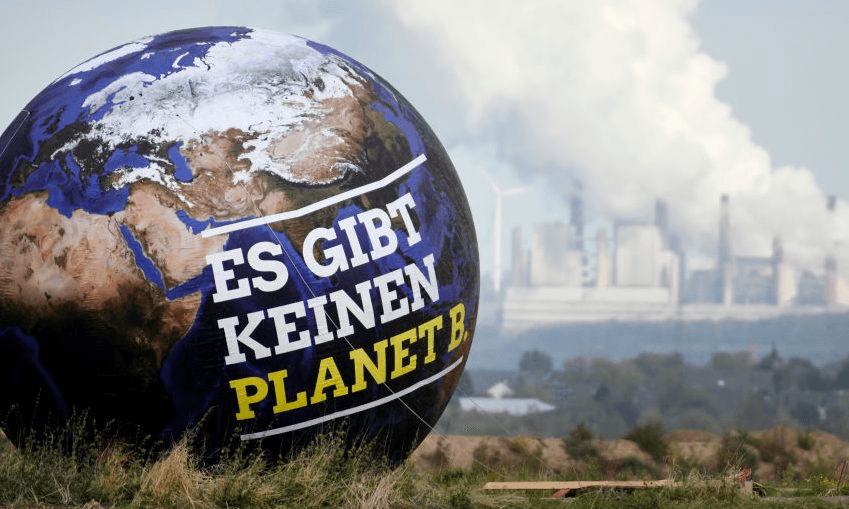 A balloon with the inscription “There is no Planet B” against a backdrop of lignite-fired power plants – taken on the fringes of the North Rhine-Westphalian Green Party Convention. Photo: Ina Fassbender/dpa/getty 
