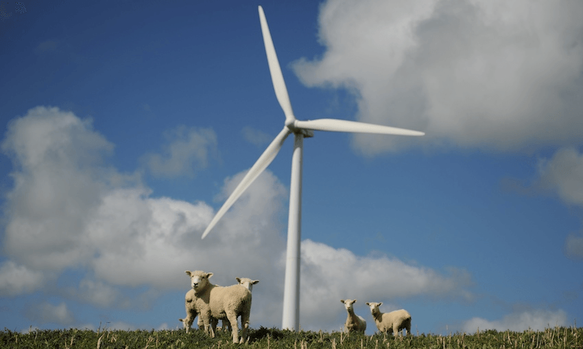 a wind turbine with fluffy white clouds behind it and fluffy white sheep around it