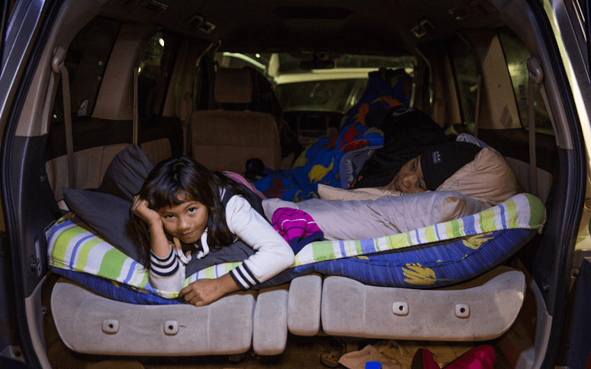 A family sleeps in their car in south Auckland in a show of solidarity for the many homeless people in the city, June 2016 (photo: RNZ) 
