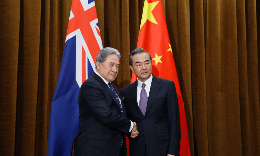 China’s Foreign Minister Wang Yi (R) and New Zealand’s Foreign Minister Winston Peters shake hands in Beijing on May 25, 2018. –  (Photo by THOMAS PETER / POOL / AFP)        (Photo credit should read THOMAS PETER/AFP/Getty Images) 

