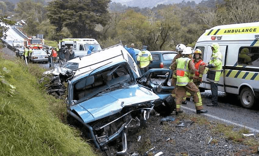 Emergency service personnel attend a serious car crash south of the Brynderwyn Range, Northland, in 2004. (Photo: teara.govt.nz) 
