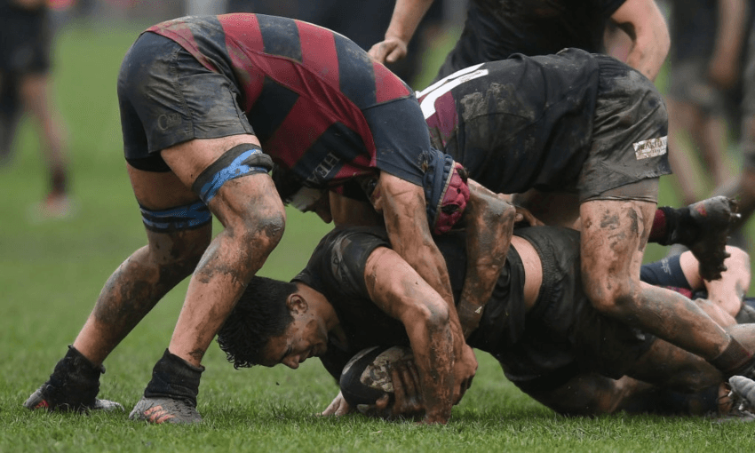 Schoolboy rugby players hitting a ruck on a muddy field (Getty Images)  
