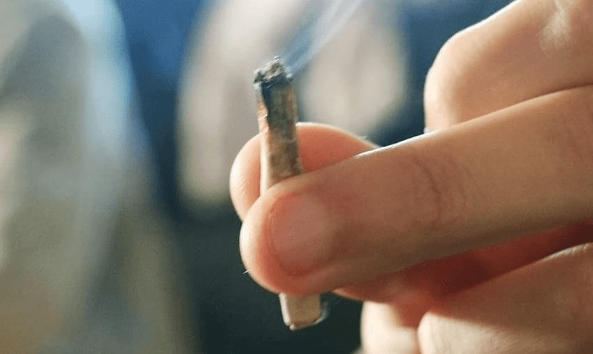 Cropped Hand Of Man Holding Joint