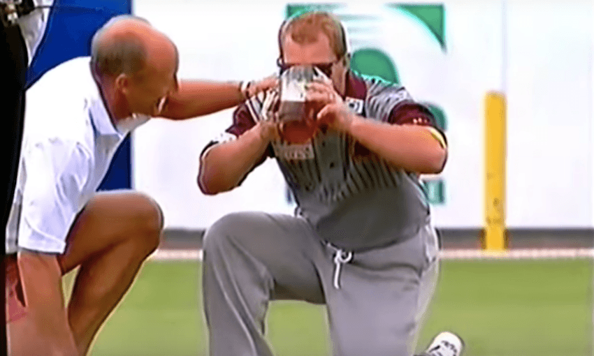 Allan ‘Alfie’ Langer pauses mid-over to drink a jug of beer during the Allan Border testimonial in 1993 
