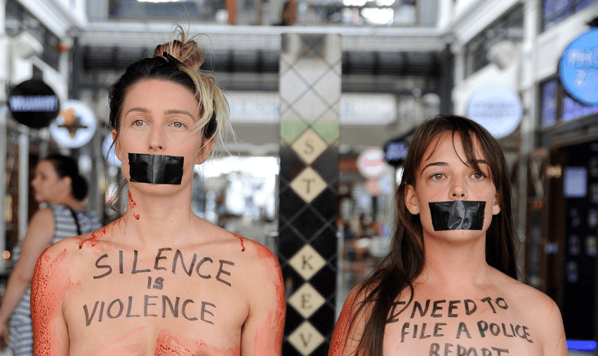 Kyah Dove and Jazmine Roze Phillips on K Road protesting naked and covered in fake blood (Photo: Sara Cowdell) 
